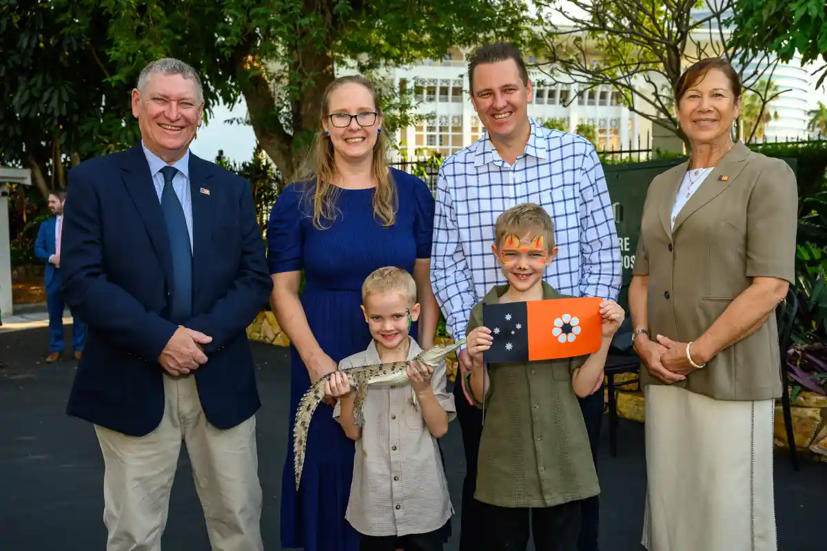 His Honour poses for a group photo with a family on Territory Day